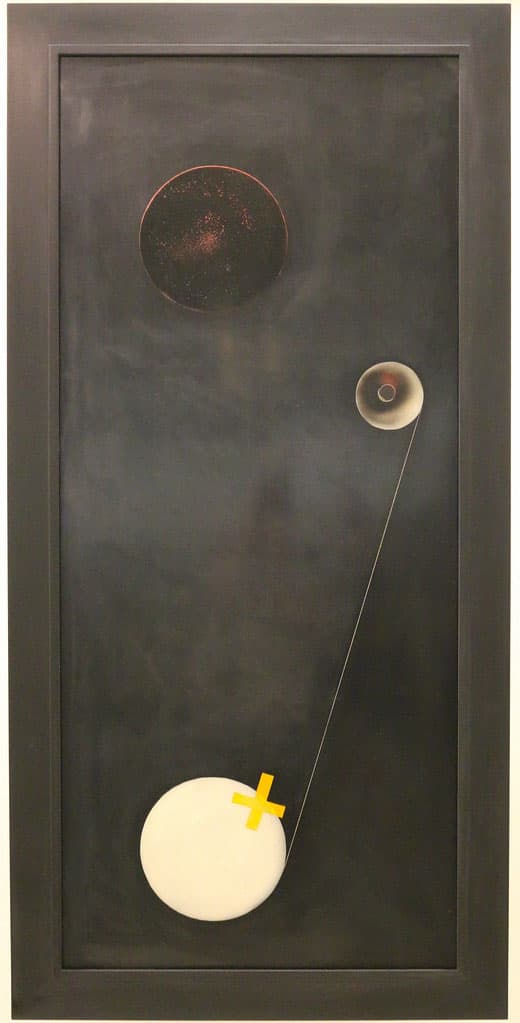 Abstract artwork featuring a dark background with a large black circle near the top, a smaller cone-like shape connected by a thin line to a white circular form at the bottom. A bright yellow cross overlays the white circle, creating a minimalist and geometric composition.