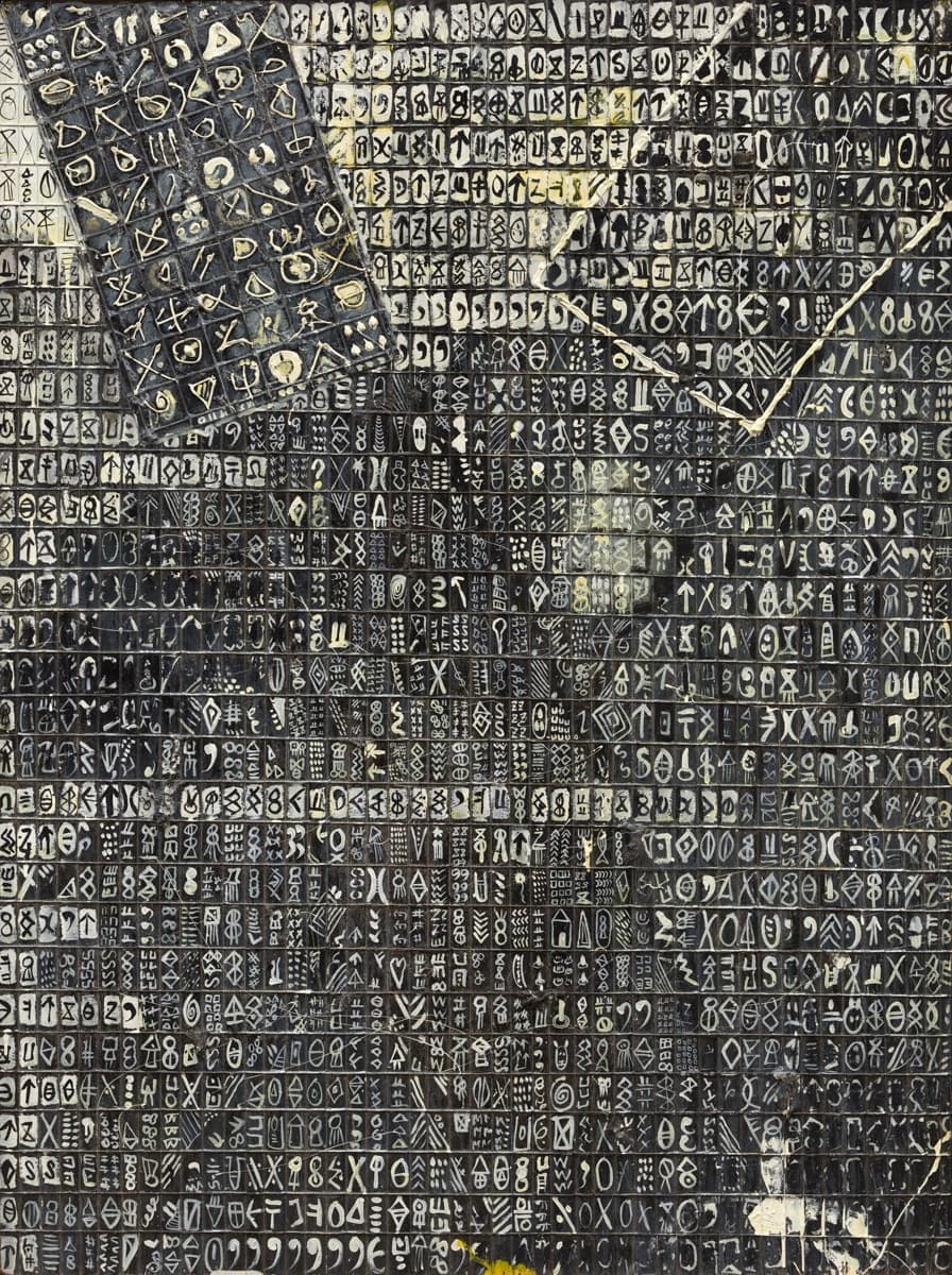 A densely packed grid of hand-drawn symbols and shapes in black, white, and gray, arranged in rows and columns, resembling a coded or ancient script.