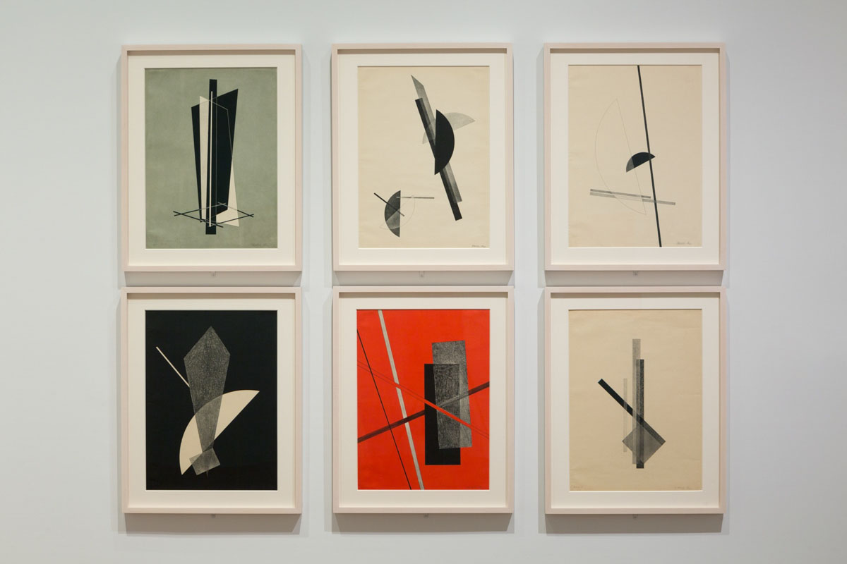 A gallery display of six minimalist abstract artworks, each featuring geometric shapes and lines. The color palette includes black, white, grey, and a striking red background in one piece, creating contrast and balance between the forms.