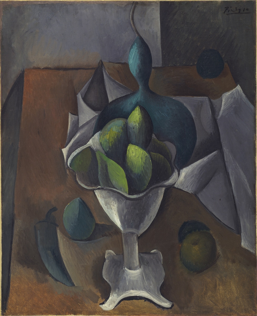 A cubist still life featuring a white, pedestal fruit bowl holding green fruits, with additional fruits scattered around the base. The background is abstract, with folds of white cloth and geometric forms in brown and grey tones. The shapes of the fruits and the bowl are slightly distorted, characteristic of the cubist style, giving the scene a fragmented and multi-dimensional appearance.