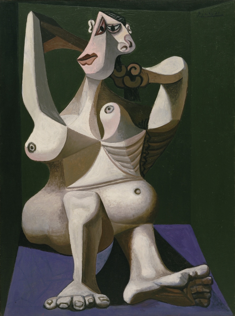 A cubist painting of a seated woman with exaggerated, angular body parts, including large feet, a stylized face, and prominent geometric breasts. Her body is composed of overlapping planes and sharp shapes, rendered in shades of brown, white, and muted colors, set against a dark green background. The woman appears to be adjusting her hair, with one arm raised and bent.